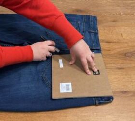 She places a picture frame over an old pair of jeans for this beyond-genius storage hack