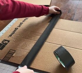 She sticks duct tape over a big piece of cardboard to make food shopping less of a chore