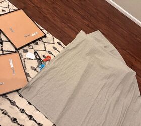 She lays her picture frames on some fabric for one of the easiest upgrades out there