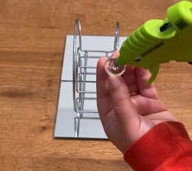 She glues glass gems to a Dollar Tree napkin holder for one of the coolest ideas we've seen all week