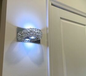 napkin holder wall sconce, Finished Dollar Tree glam wall sconce glowing on a living room wall