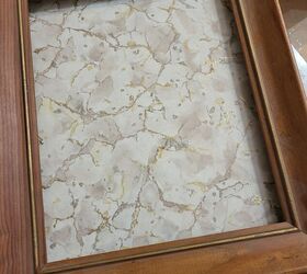 She starts by putting a piece of laminate in a picture frame for this really interesting decor idea