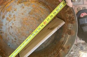 She measures a wooden board in this rusty old tub for the most interesting reason