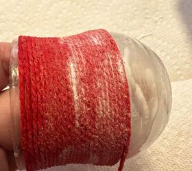Instead of trashing that empty glass jar, grab some yarn for a really charming idea