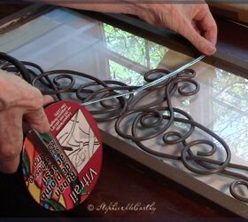 She put a wrought-iron wall scroll on her window for a timeless upgrade that only looks like it cost a fortune