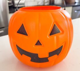 She sticks this into a plastic pumpkin bucket for one of the coolest outdoor decor hacks we've seen in a while