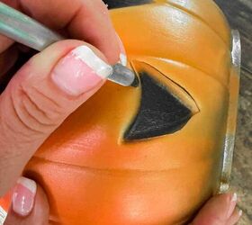 She cuts the eyes out of these trick-or-treat buckets for a really cute last-minute Halloween decor