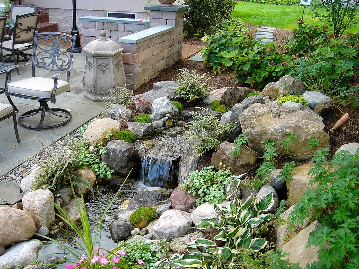 stone amp brick patio repair led lighting waterfalls fountain and landscaping in, fire pit, patio, ponds water features, Brighton NY Disappearing Pondless Waterfall Water feature Fountain in Brighton NY by Acorn Landscaping of Rochester NY The Patio is pitched so the rain water goes right to this Low Maintenance Water Feature Brighton NY