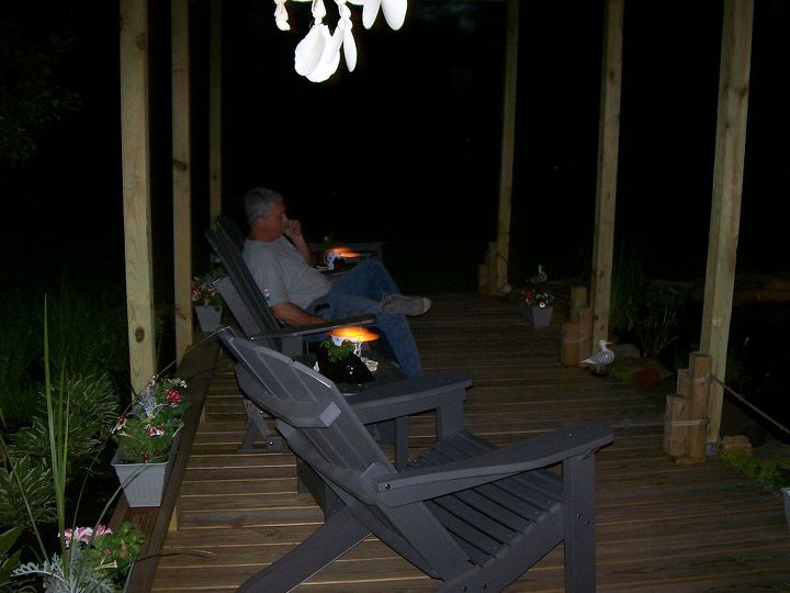 my wonderful husband built this pond and pergola deck for us 2 years ago we love, outdoor living, ponds water features, My husband evjoying the evening on the deck