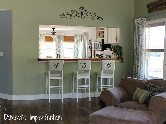 domestic imperfection home tour, home decor, Living room looking onto the kitchen dining room