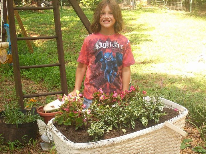 recycled antique baby bassinett, flowers, gardening, outdoor living, repurposing upcycling, This kid loves growing things maybe she will keep it up as she gets older i hope