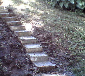 we made steps from decorative concrete blocks, concrete masonry, gardening, repurposing upcycling, stairs, My grandson helped with the heavy stuff I had bags of Quckcrete left by my x huband So all materials cost zip I am going to make a cement slab at the base and landing Then add hostas perrenial flowering plants on the sides