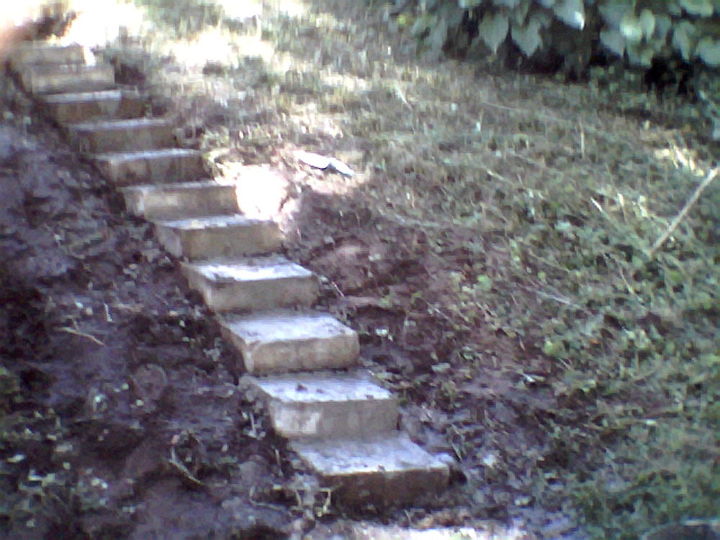 we made steps from decorative concrete blocks, concrete masonry, gardening, repurposing upcycling, stairs, My grandson helped with the heavy stuff I had bags of Quckcrete left by my x huband So all materials cost zip I am going to make a cement slab at the base and landing Then add hostas perrenial flowering plants on the sides