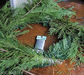 how to make a semi natural evergreen wreath, crafts, gardening, wreaths, Then I layered the bunches of greens around the wreath on top of one another in a semi circular pattern I wrapped each bundle with a long continuous length of floral wire to secure them to the form