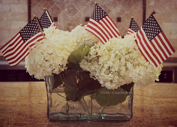 easy flag centerpiece, patriotic decor ideas, seasonal holiday d cor, If your lucky you grow these amazing Snow Ball Hydrangea in your yard This year mine are bigger than ever so beautiful I cut a few flowers and place them in a vase and added five small flags that I found at Micheal s