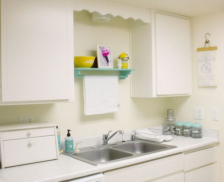 cute way to maximize kitchen counter space, home decor, kitchen design, I hung a shelf with a towel rack above the sink and use a vintage wire basket to hold hand towels Canisters hold vintage cookie cutters