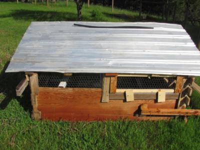 building a chicken tractor coop with recycled materials, homesteading, pallet, pets animals, repurposing upcycling, Recycled roofing chicken wire are obvious from the back view