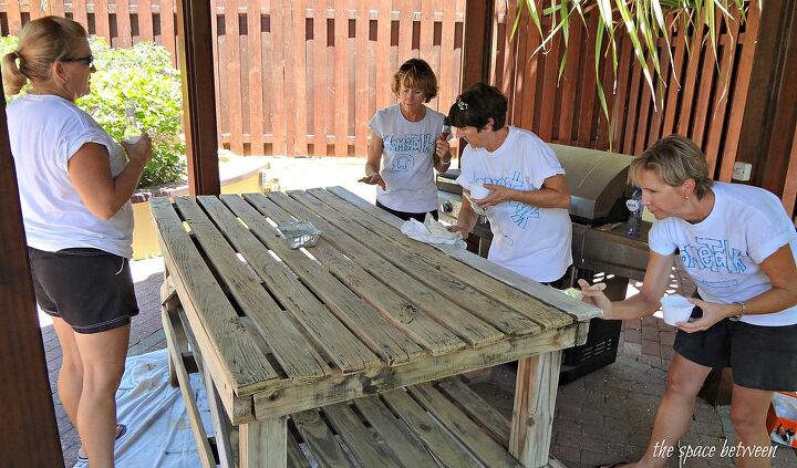one way to make a pool party complete is to add in a few diy projects and wear, painted furniture, hard at work