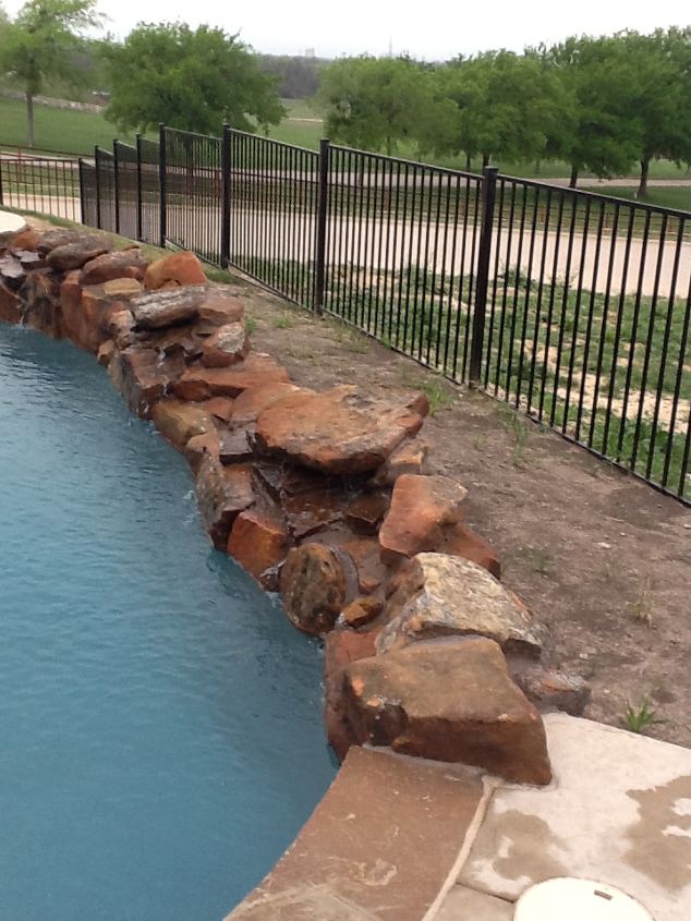 how do we landscape around our pool, landscape, pool designs, This is the backside of the pool We would like to use small rock for covering No idea what to plant Remember this can be viewed by folks driving by