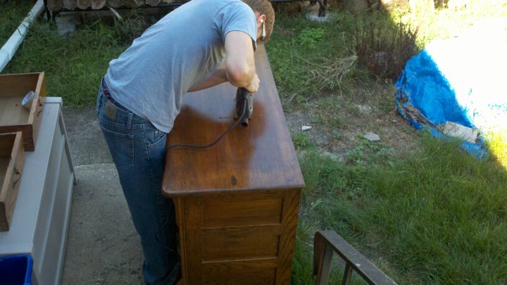 my hubby working on our main floor bathroom vanity we purchased the antique dresser, bathroom ideas, diy, home decor, The first cut into the antique dresser