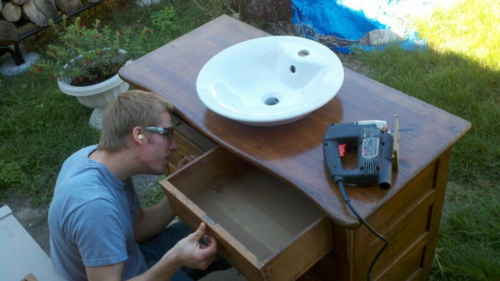 my hubby working on our main floor bathroom vanity we purchased the antique dresser, bathroom ideas, diy, home decor, Now on to the drawers