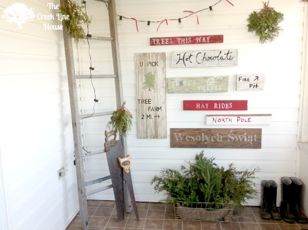 a tree farm inspired sign wall in the mudroom, christmas decorations, laundry rooms, painting, seasonal holiday decor