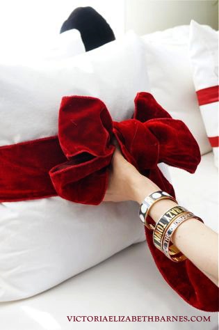 simple valentine s decorating tie a red bow around your sofa pillows, crafts, seasonal holiday decor, valentines day ideas, If you wrap the pillow with a separate piece than you use to make the bow it will keep the band wide instead of getting scrunched up