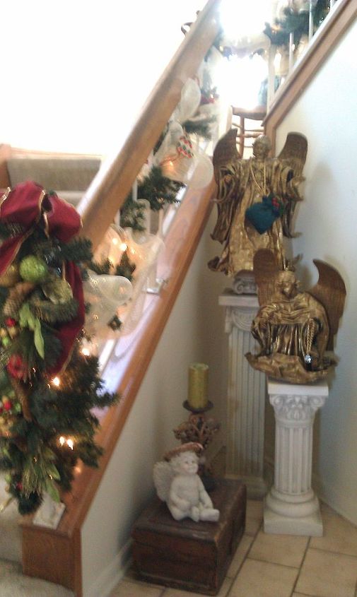 welcome to our christmas, christmas decorations, seasonal holiday decor, The stairway cove in the entry way The large angels are some of my favorite decorations
