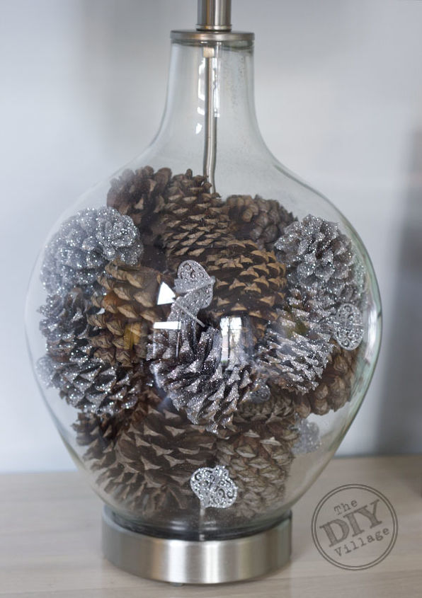 winter wonderland holiday lamp decorating challenge, lighting, seasonal holiday decor, Fill the base of your lamp with glittered and regular pine cones Throw some small glittered ornaments into the mix for an extra touch