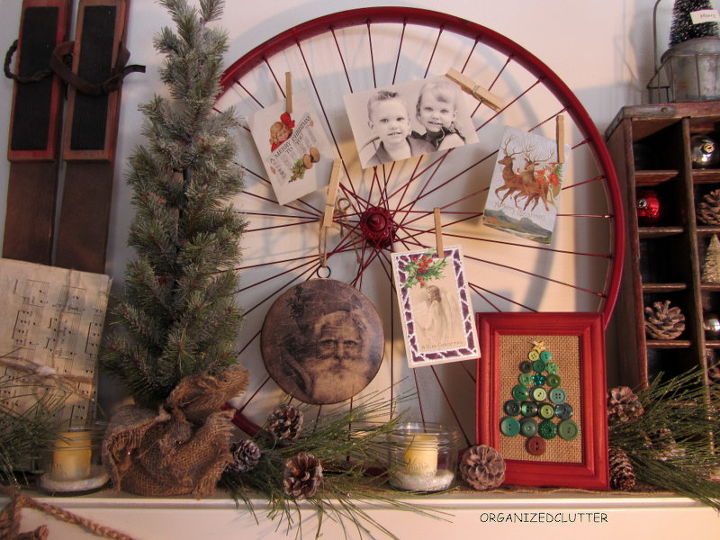 vintage rustic christmas mantel, christmas decorations, repurposing upcycling, seasonal holiday decor, Bike rim spray painted red with photos and vintage Christmas postcards My framed button tree