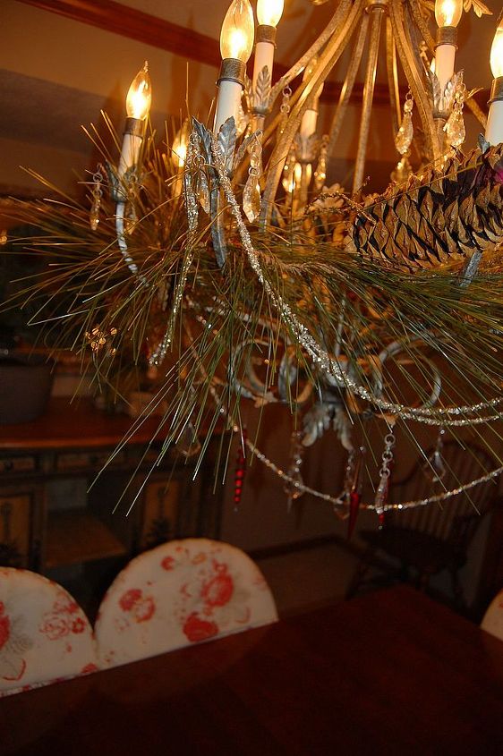 antique christmas decor, christmas decorations, repurposing upcycling, seasonal holiday decor, wreaths, Antique tinsel I strung from my chandelier with some greenery I used more glass ice cycle ornaments on this light as well