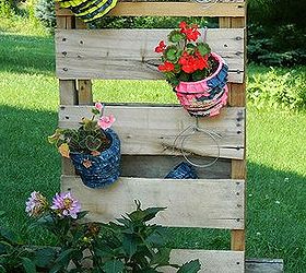 fun and bright brick patio, outdoor furniture, outdoor living, patio, 1 2 a pallet some wire and s hooks makes for a fun planter holder