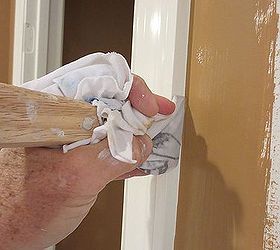 painting a straight line next to the trim trick, To make the line even straighter take your 5 in 1 tool wrapped with a wet rag and drag it down the corner At just the right angle this will give you a crisp straight line