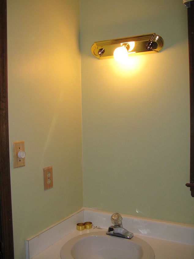 tired of that old wallpaper check out what i did to our master bath, bathroom ideas, paint colors, painting, wall decor, Here I ve changed out the light fixture to a more simple brass 3 round bulb fixture