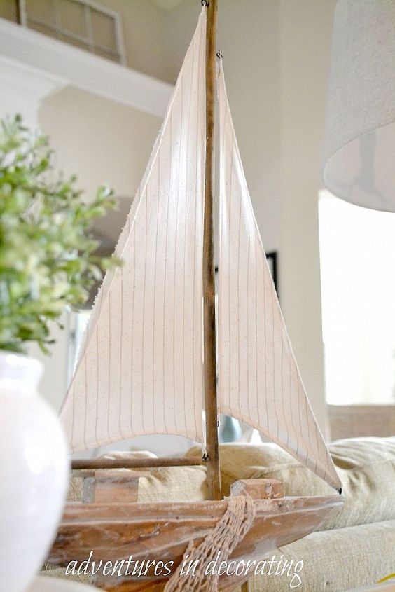 a simple vignette, home decor, A cute ship from Home Goods takes center stage
