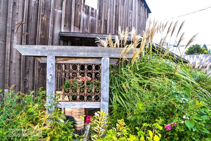falling for a garden gone wild with amazing reclaimed features, flowers, gardening, outdoor living, repurposing upcycling, There were several of these neat structures with metal panels much like room screens Gorgeous