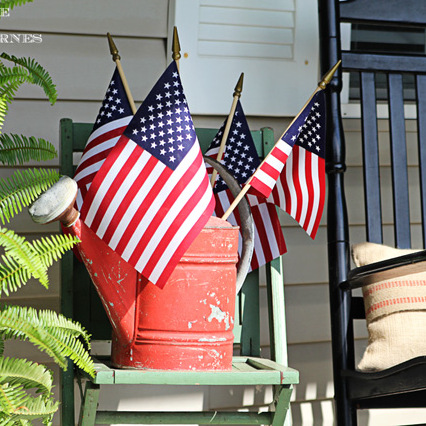 celebrating the red white and blue in style, outdoor living, patriotic decor ideas, seasonal holiday decor, My old watering can makes a perfect flag holder