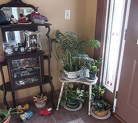 the welcoming plant station, foyer, gardening, A vintage kidney shaped bench is a cozy plant stand her collection of vintage car shape planters add to the charm