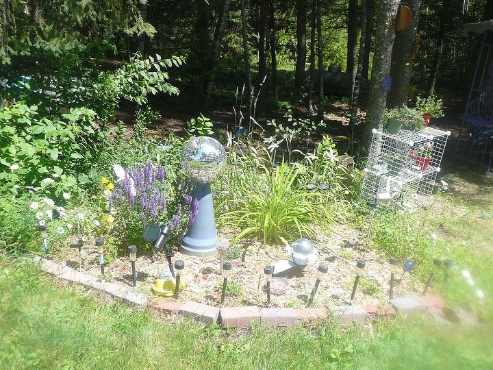 whimsical garden ideas, gardening, This garden has an old disco mirror ball in it I have a solar spot light on it so at night it reflects tiny little lights