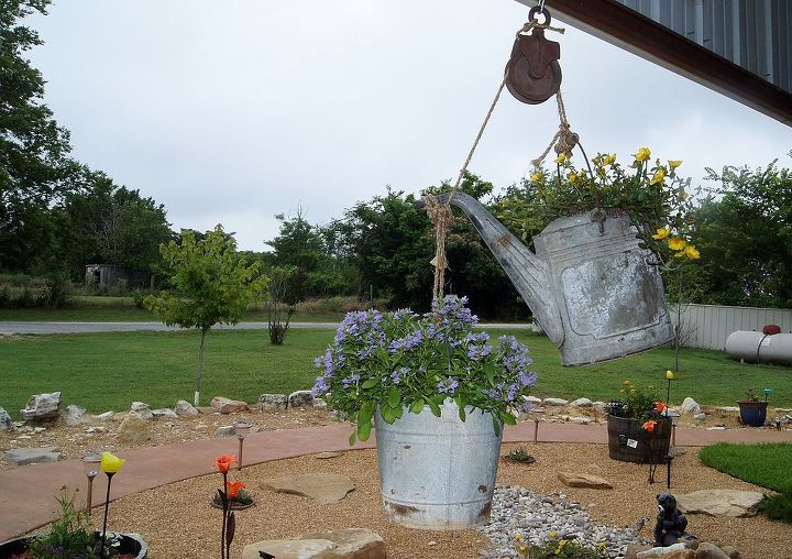 latest landscaping project, gardening, landscape, Old watering can and bucket tied to a rope and pulley