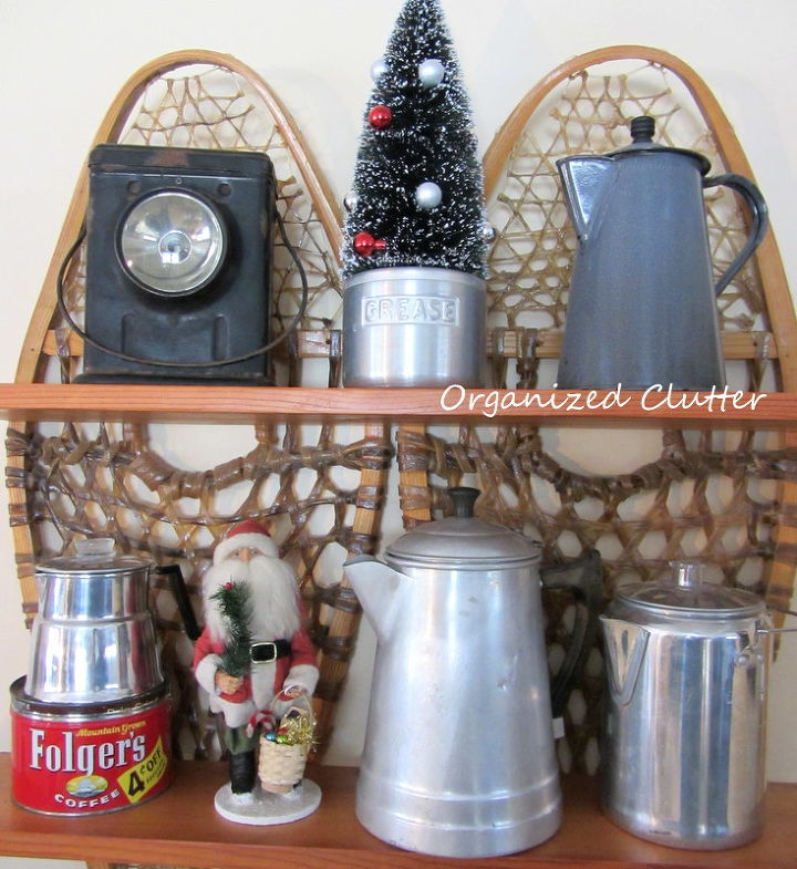 rustic christmas vignettes in the den, seasonal holiday d cor, A collection of vintage coffee pots on the snowshoe shelf plus a bottle brush tree in a grease canister and a vintage look Santa