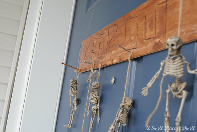 how to make a spooky skeleton door hanging, crafts, curb appeal, doors, garages, halloween decorations, seasonal holiday decor, wreaths, Skeleton Door Hanging