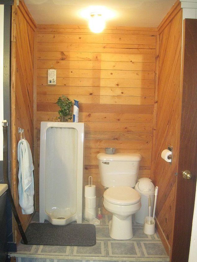 bathroom remodel, bathroom ideas, remodeling, Before Walls had been made from old pallets The toilet and yes that s a urinal were on a platform because of a plumbing issue