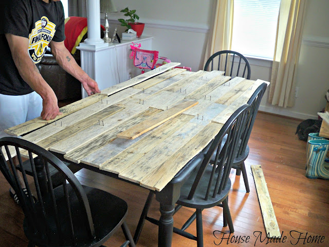 diy pallet farmhouse table, painted furniture, pallet, rustic furniture, urban living, Once he had enough he started to lay them out on the table for placement and size I also didn t want everything to match up again I like rustic and when you have three boys in the house my two step son s and my eight year old brother who visits often and a two year old little girl who is more destructive then her older brothers rustic is great Because when it does get nicked here and there it looks like it was supposed to be that way Tricks of a mother