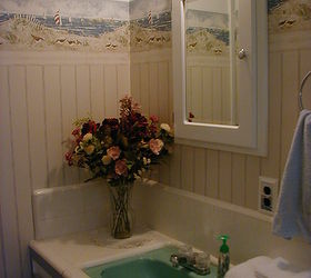 50s bathroom budget facelift, bathroom ideas, home decor, The new medicine chest really brought a nice character to the room I painted a faux bead board below the border which has the sand colors The walls are 50s plaster and installing real bead board would have been a pain Faux works