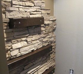 how to install faux stone on a inside wall, concrete masonry, diy, how to, wall decor, To go with the theme of our fireplace we installed random pices of wood that we stained for a more rustic feel
