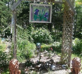 whimsical garden ideas, gardening, My son built this arbor It is covered in purple and white lights The stained glass picture is reflected by the lights at night and shines beautifully in the sun by day