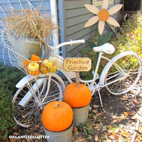 primping my bike for fall, gardening, seasonal holiday d cor, I also added a couple of large pumpkins to two galvanized buckets a sign and a wooden daisy