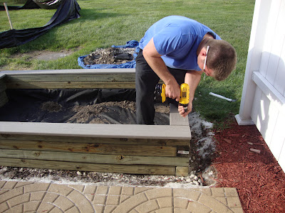 diy sandbox, Last addition Trex decking being screwed in through the top at all four corners