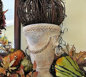 my fall mantel natural elements and textures pumpkins gourds pine cones lichen, home decor, seasonal holiday decor, wreaths, Twine pumpkins add texture to my frenchy lion s head urns Love the muted colors